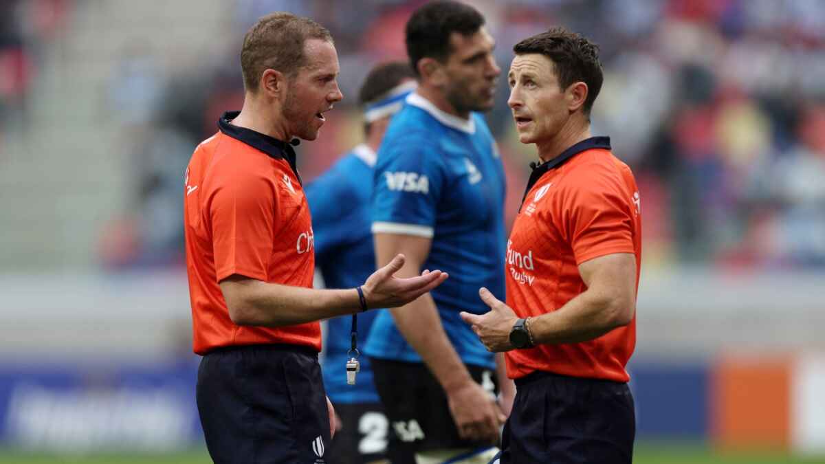 Referee Angus Gardner speaks with his assistant referee Paul Williams