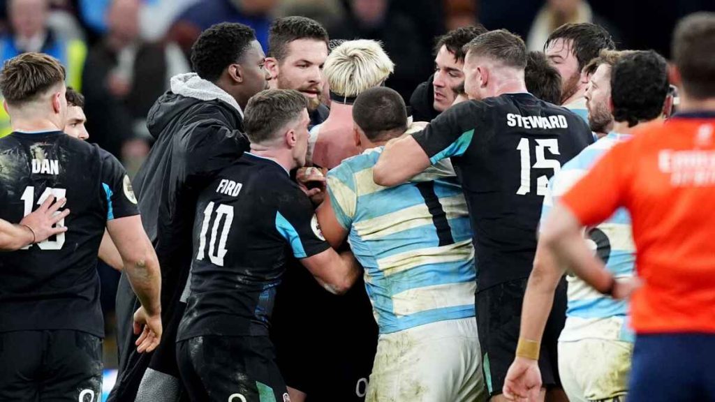 England's Henry Pollock (centre) is restrained by his team mates