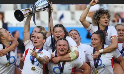 England captain Meg Jones holds the trophy aloft