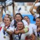 England captain Meg Jones holds the trophy aloft