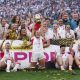 Zoe Aldcroft lifts the Women’s Rugby World Cup trophy for England