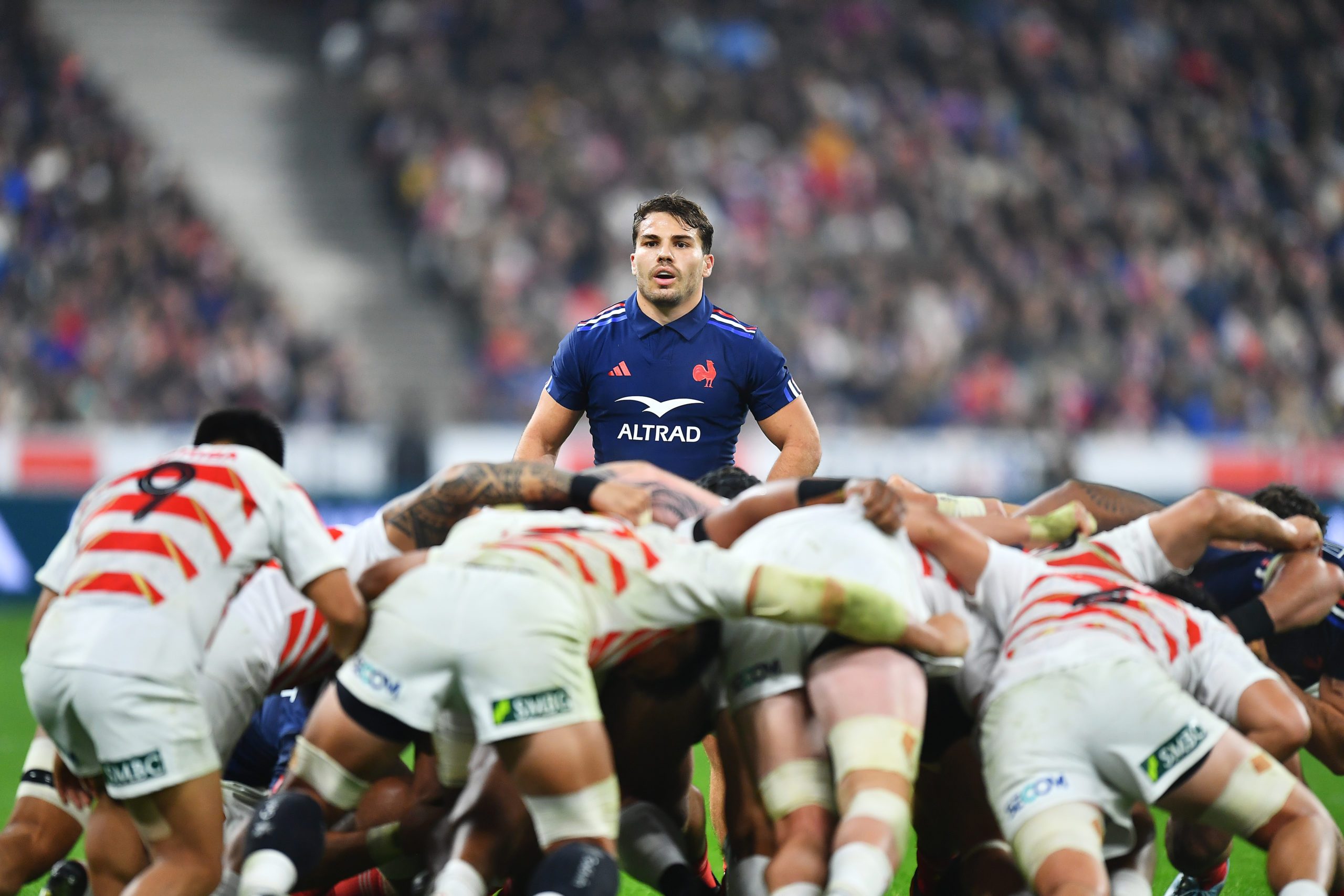 Antoine Dupont of France looks on over a scrum
