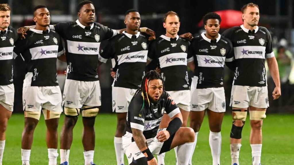Ma'a Nonu performs his solo haka as his Sharks team-mates watch on from behind.