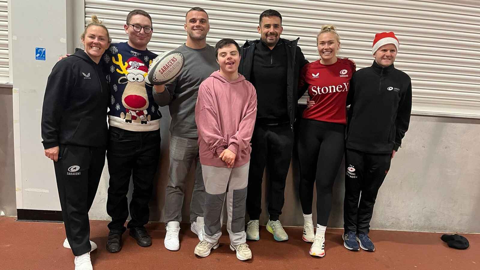 Ben Earl and Alex Lozowski (centre) help lead festive celebrations for young people with learning difficulties at the Saracens Foundation Christmas party