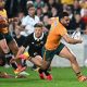 Tom Wright going over to score for Australia in their 50-19 defeat to New Zealand at Eden Park yesterday