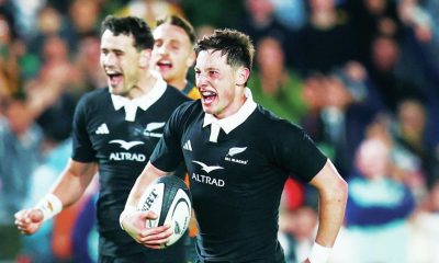 Cam Roigard runs through to score for New Zealand
