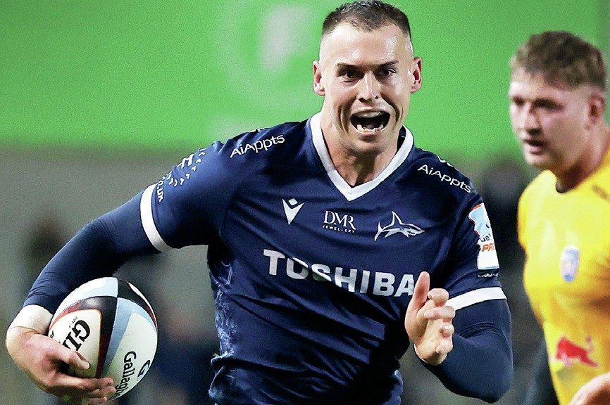 Tom Roebuck runs through for his second try for Sale Sharks