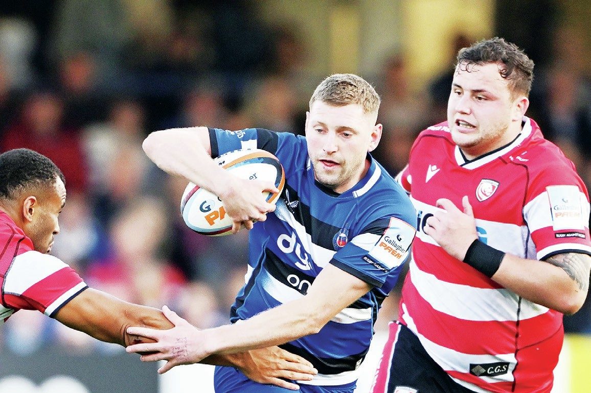 Finn Russell avoids the tackle of Will Joseph to set up a Bath attack