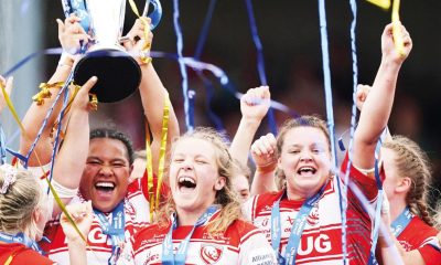 England stars Natasha Hunt and Zoe Aldcroft celebrate as Gloucester-Hartpury’s Sisilia Tuipulotu lifts the trophy last season