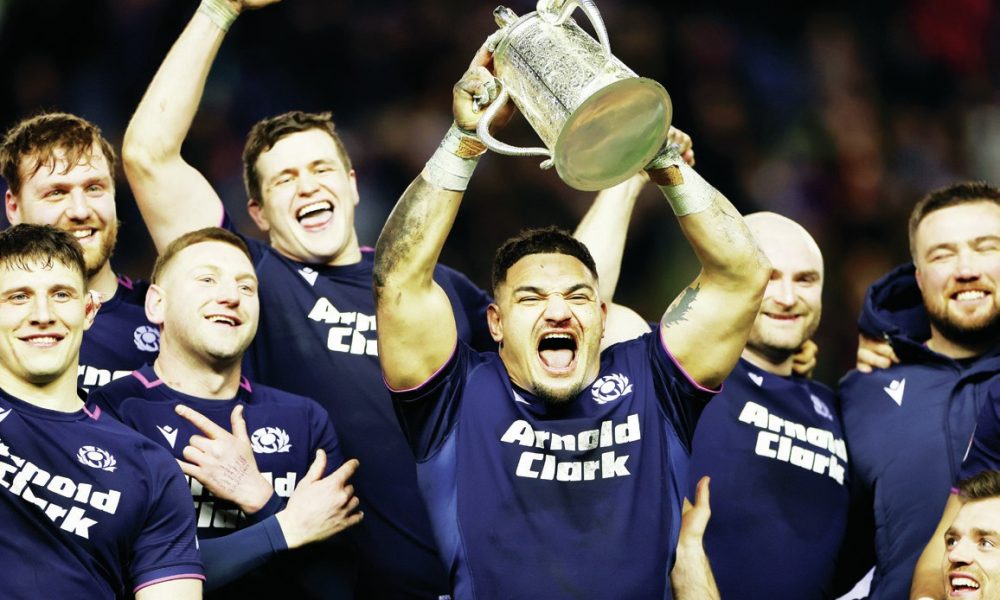 Sione Tuipulotu lifts the trophy for Scotland