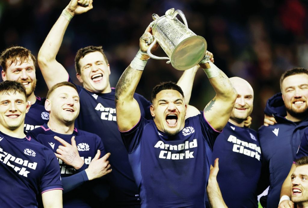 Sione Tuipulotu lifts the trophy for Scotland