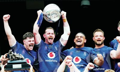 Navy captain Jarrard Hayler lifts the trophy